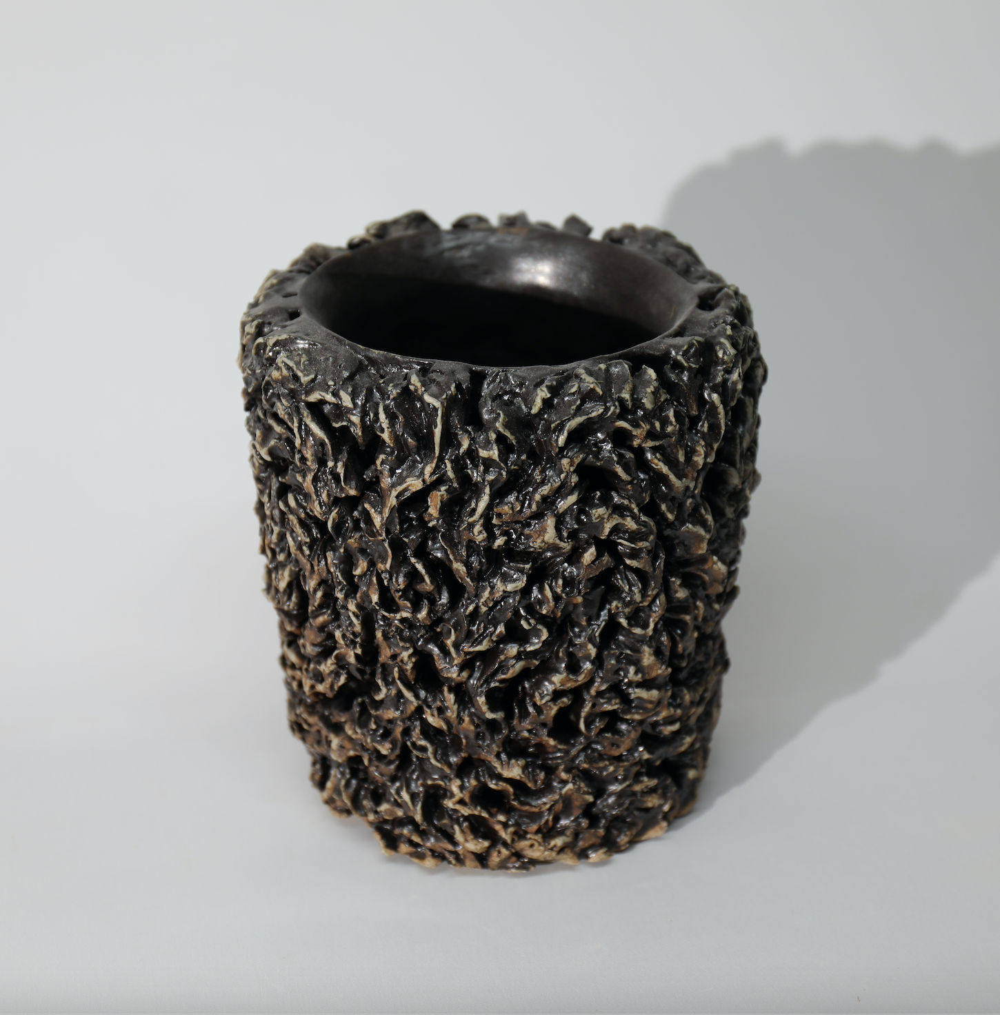 Textured ceramic vase on a white background